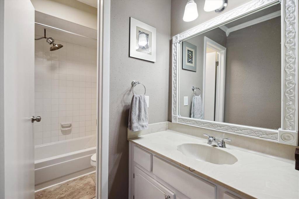 Your primary bathroom has an updated mirror and vanity lighting.