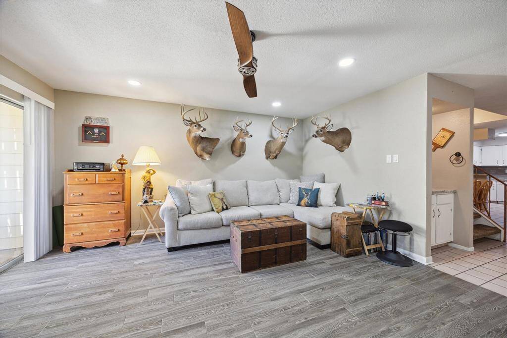 The living room lots of light and a wonderful wood-burning fireplace for your enjoyment. It has a large glass sliding door that opens up to your large patio. This room has been updated with beautiful gray tile that Has the appearance of hardwood.