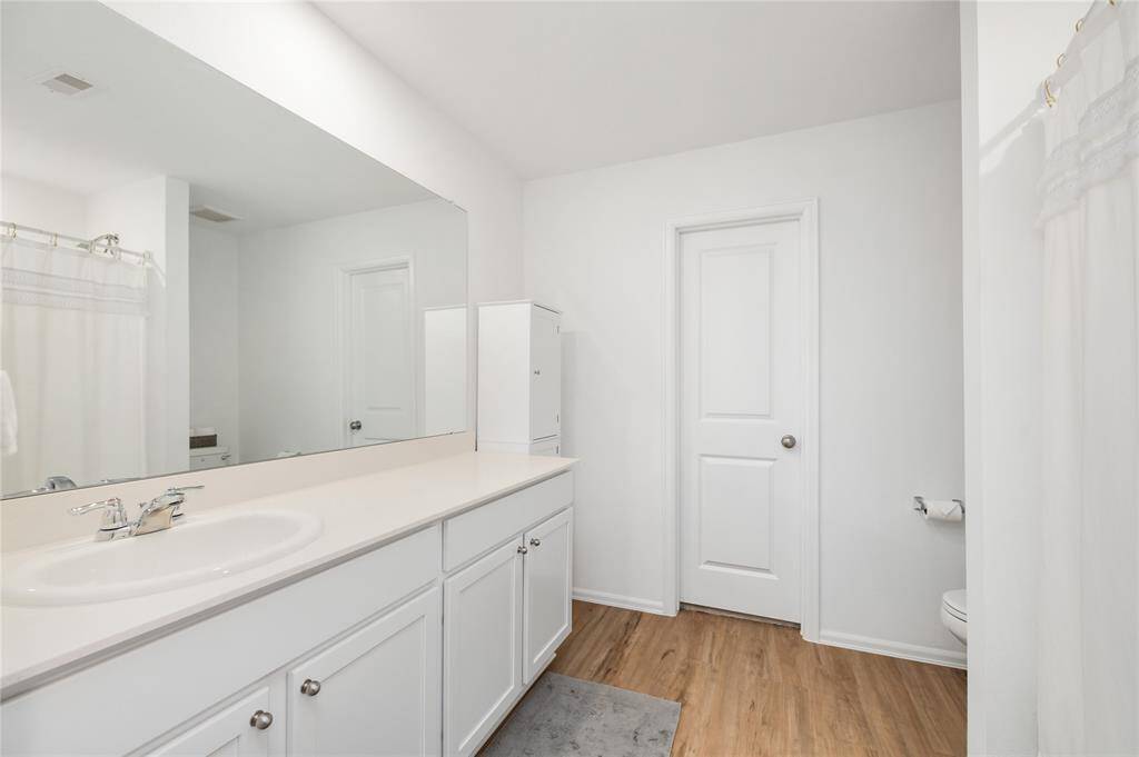 Luxurious primary bath with double vanities and spa-like lightiing