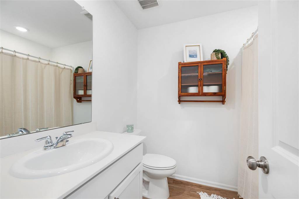 Here is the secondary bathroom in this hallway. It has a convenient tub/shower combo, storage space under the sink, and LVP flooring.