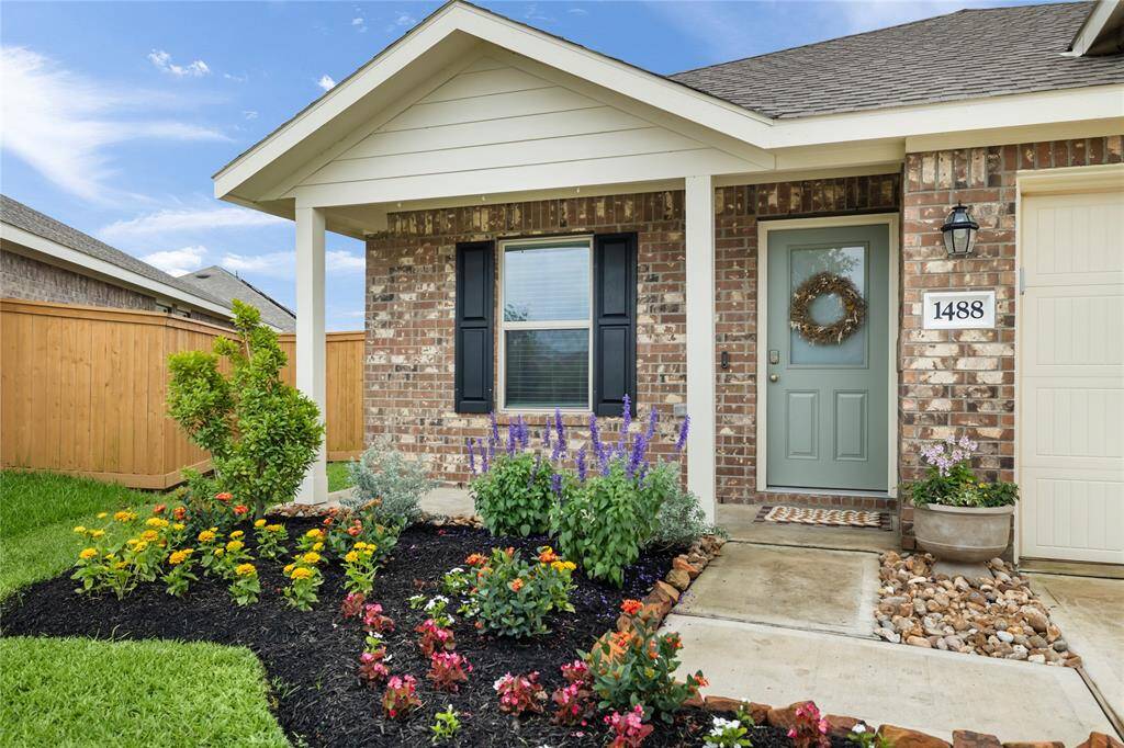 A classic front porch with beautiful stone accents and garden that adds a warm touch to the house. You will love calling this home.