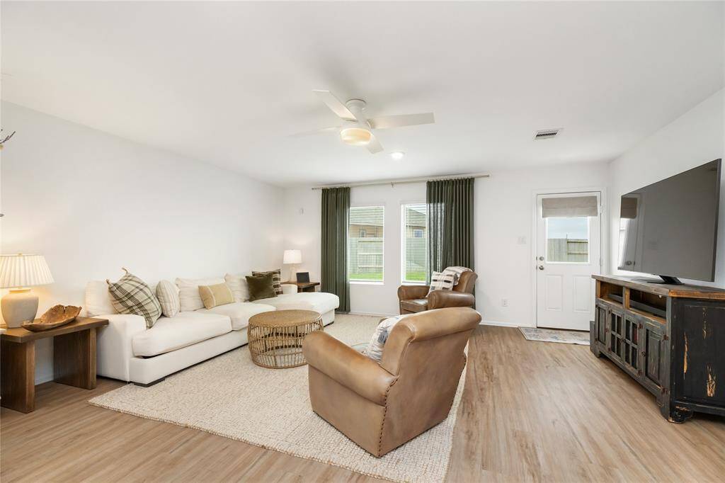 This spacious living area features hardwood floors and plenty of room to relax and entertain