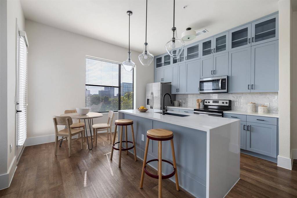 Custom kitchen with quartz counter tops and stainless steel appliances