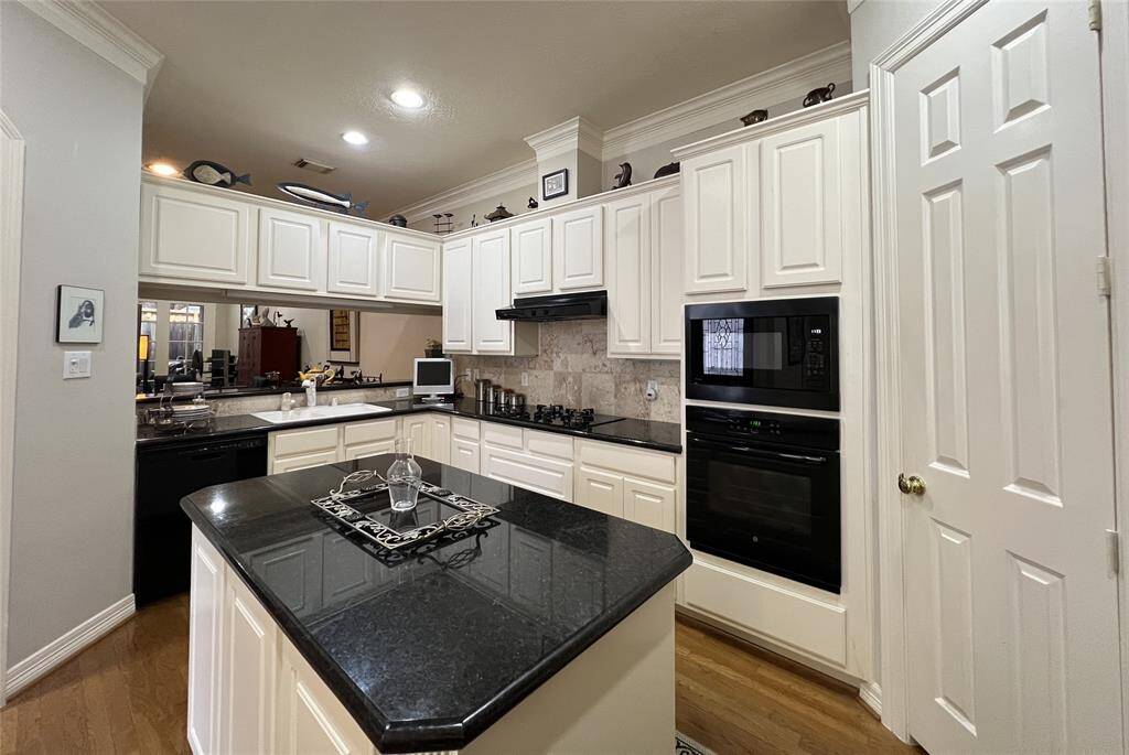 Open kitchen with granite countertops.