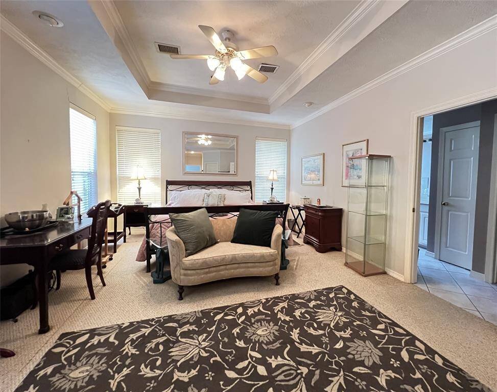 Handsomely sized primary bedroom with tray ceilings.