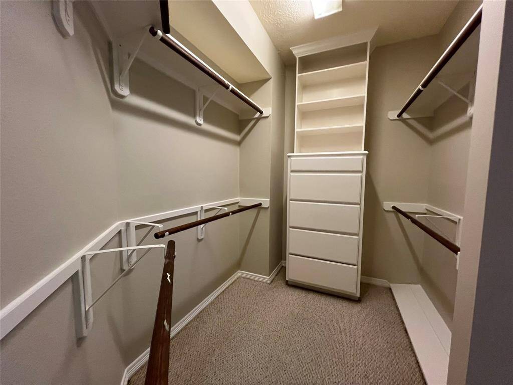 Chest of drawers, double rod space and shoe shelf in primary closet.