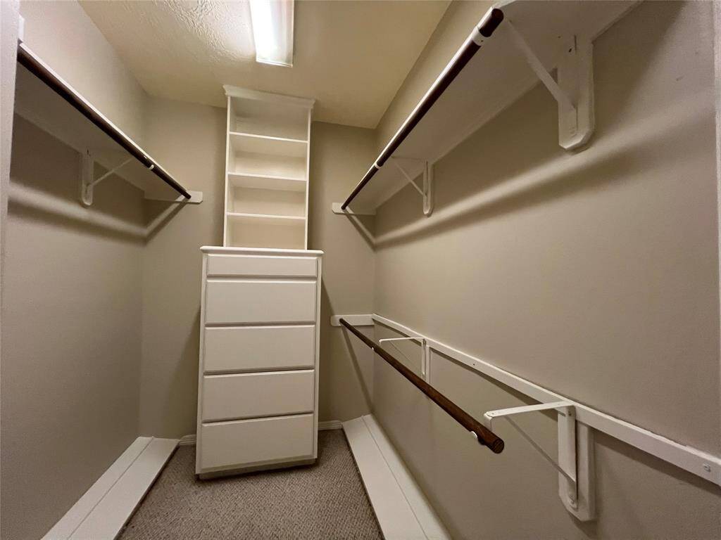 Second chest of drawers, double rod space and shoe shelves in primary closet.