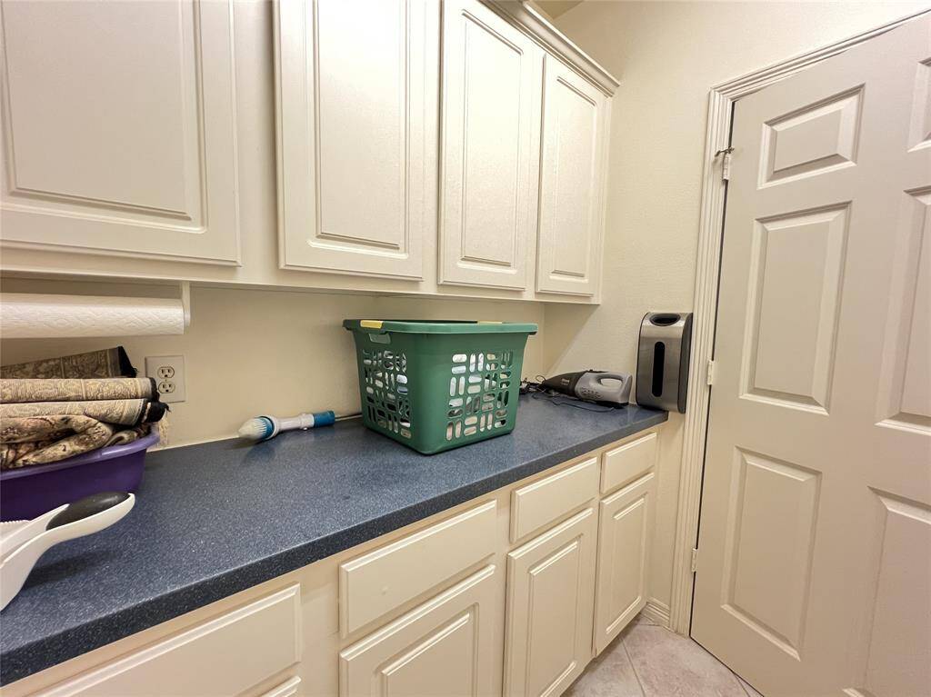 Wonderful cabinet and countertop space in the utility room.