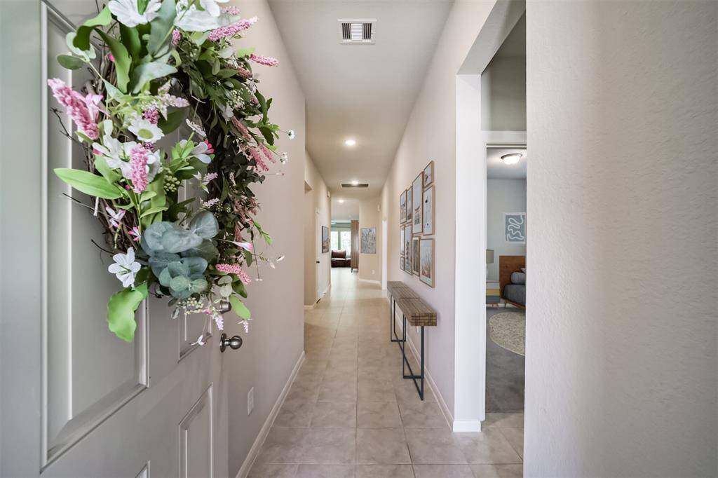 Welcoming entry with neutral tile and paint.