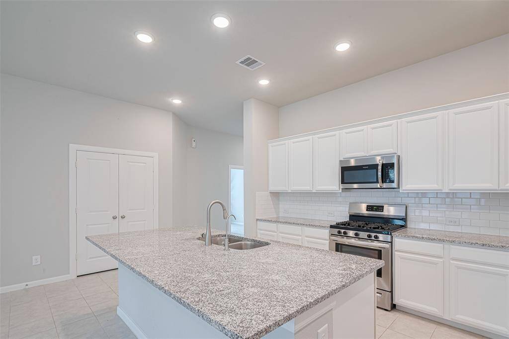 Tons of cabinet space and pantry with French doors.