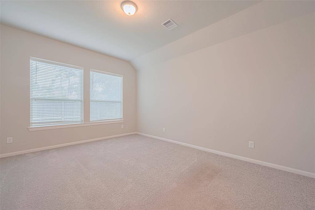 Another view of primary bedroom