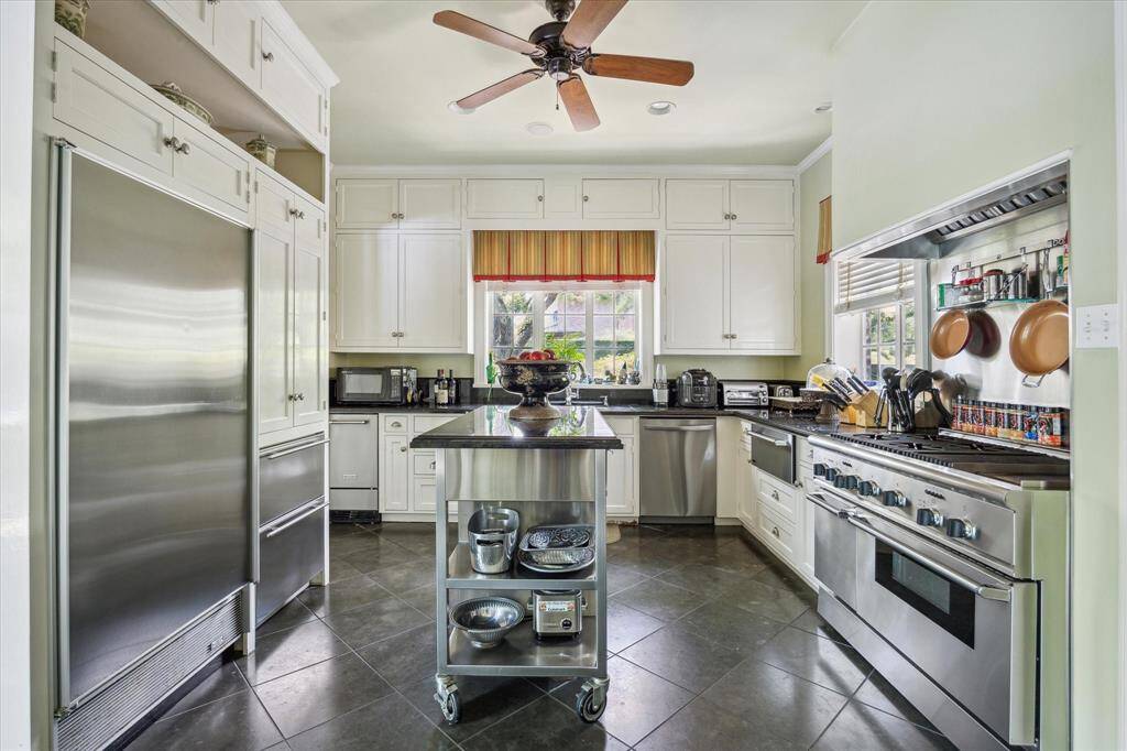 The kitchen is approximately 14' x 13' with high end stainless steel appliances.  The refrigerator is a Subzero with two freezer drawers.  The is a warming drawer in the kitchen and another warming drawer in the adjacent catering kitchen.