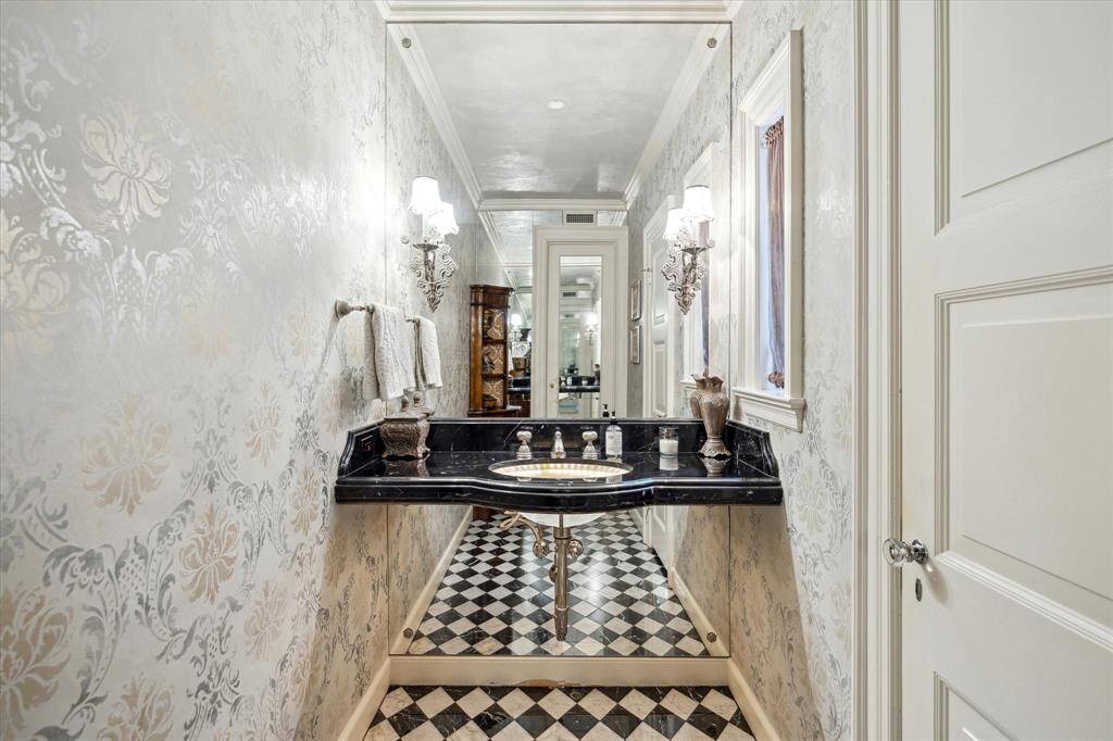 The two-room formal powder room is ultra elegant.  The stenciled walls and Venetian plaster ceiling was crafted by Segreto.