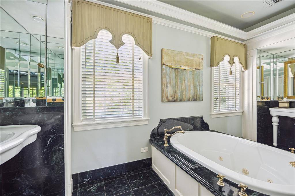 This dressing room may end up being one of your most favorite rooms in the home.  Views are to the backyard gardens and pool. There are also a wall of windows on the north side of this room overlooking the front yard and the tree-lined boulevard.