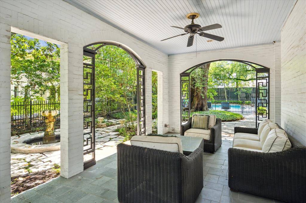 Wow...just wow.  This lovely covered veranda overlooks the side garden with fountain (fountain may need some work to get it going again) and the backyard gardens and pool.