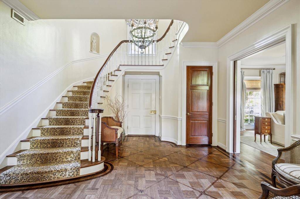 The entry and curved staircase are stunning.