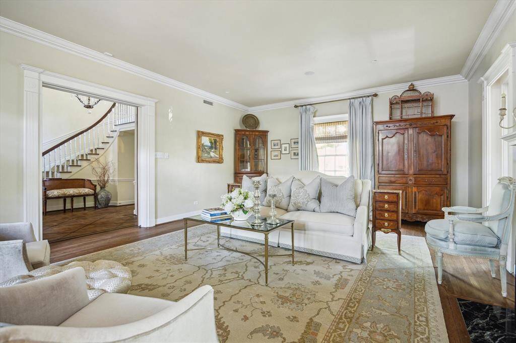 The stunning formal living room is approximately 27' x 17' with beautiful oak flooring and pocket doors.