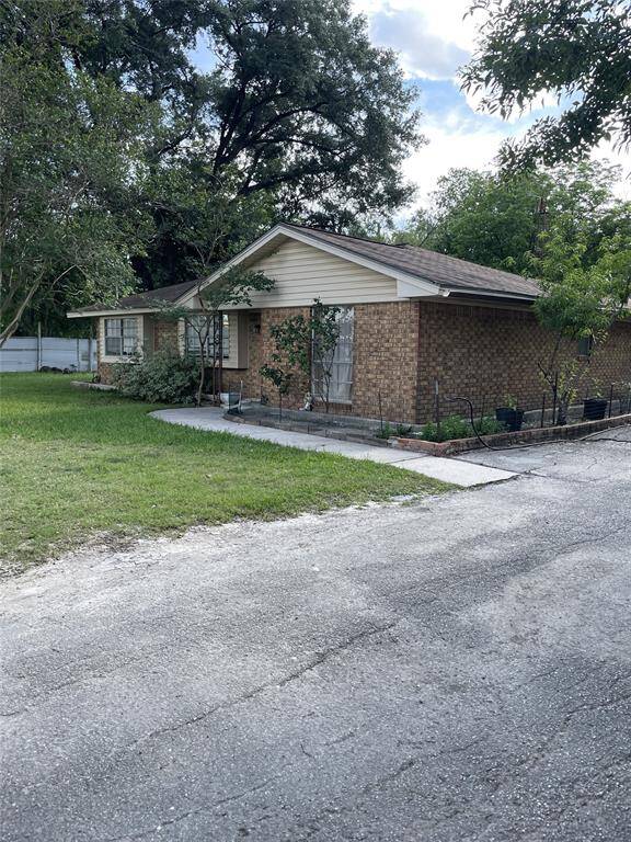 Cozy brick home with a charming front yard, nestled in a serene setting with mature trees. Perfect for those seeking a peaceful retreat.