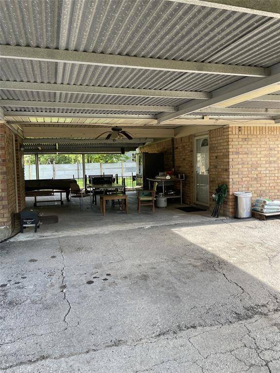 Spacious covered patio perfect for outdoor dining and entertaining, featuring ample seating and a cozy ambiance.