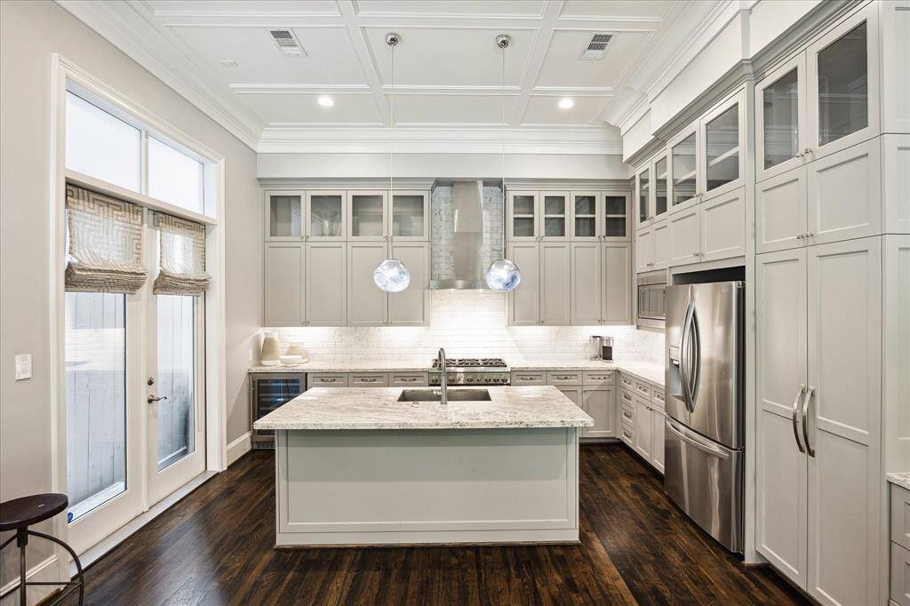 Kitchen. Quartz counter tops, center island with bar stool sitting.   Pantry, SS appliances, Beverage Frig.