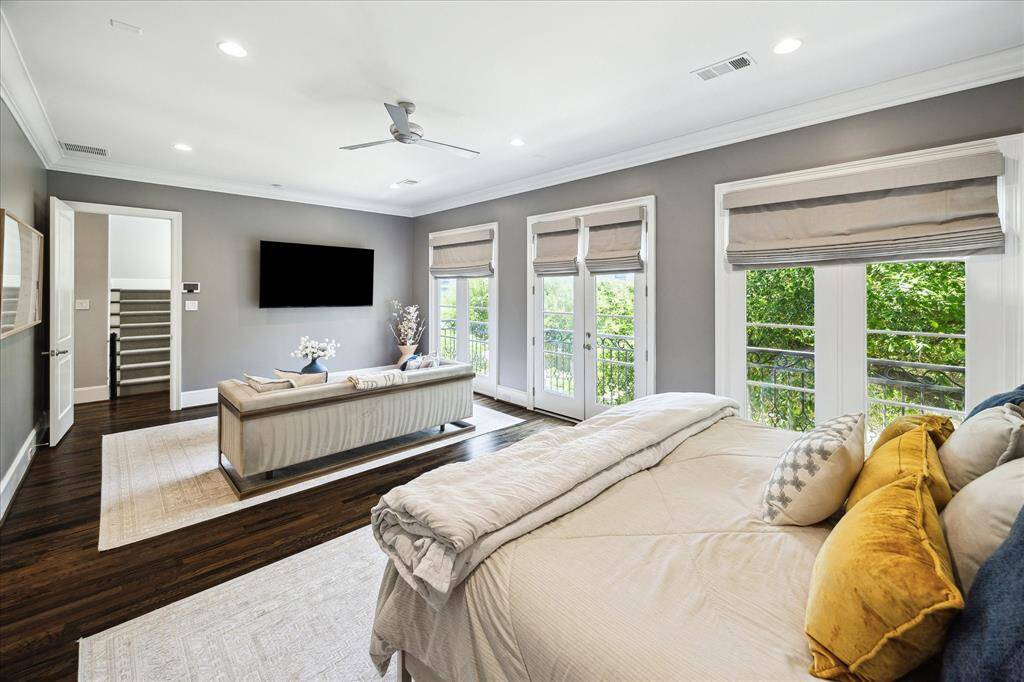 Primary Bedroom.  From the bed or sitting area, enjoy the tree top views and the tv.