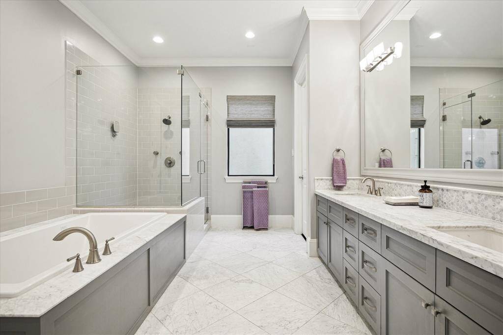Primary Bathroom.  Large spa tub, oversized walk-in shower, double sink vanity, private water closet.