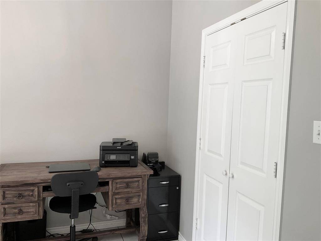 Cozy office space is very bright and conducive to focusing on work.  There is a double door closet so this room could be a 4th bedroom as well.   Light gray walls, high ceilings, a very attractive first impression.