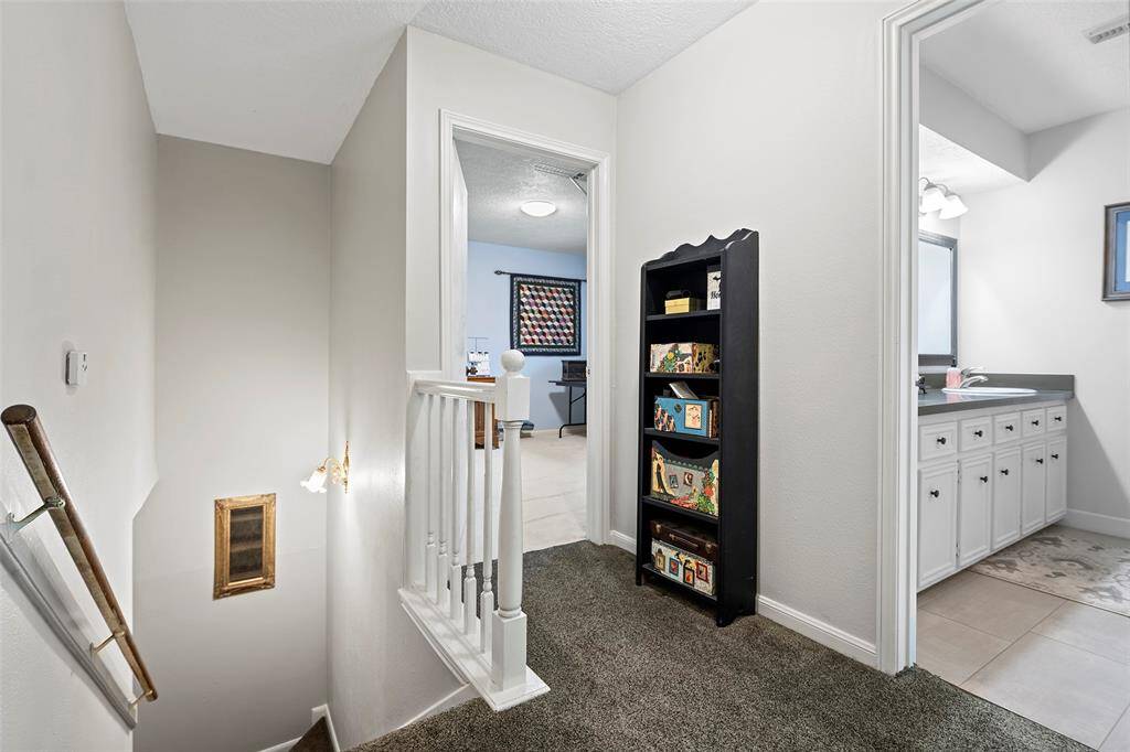 At the top of the stairs, we can see a secondary bedroom and the secondary bath.