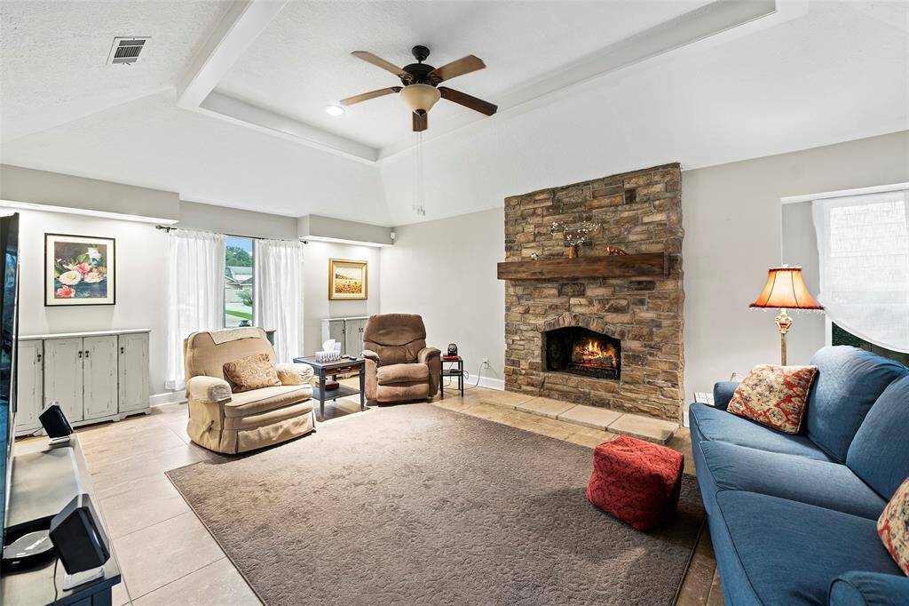 LARGE family room with tray ceiling and fireplace.