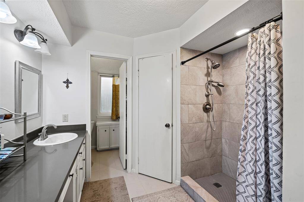 Primary bath features a renovated, oversized shower and separate toilet room.