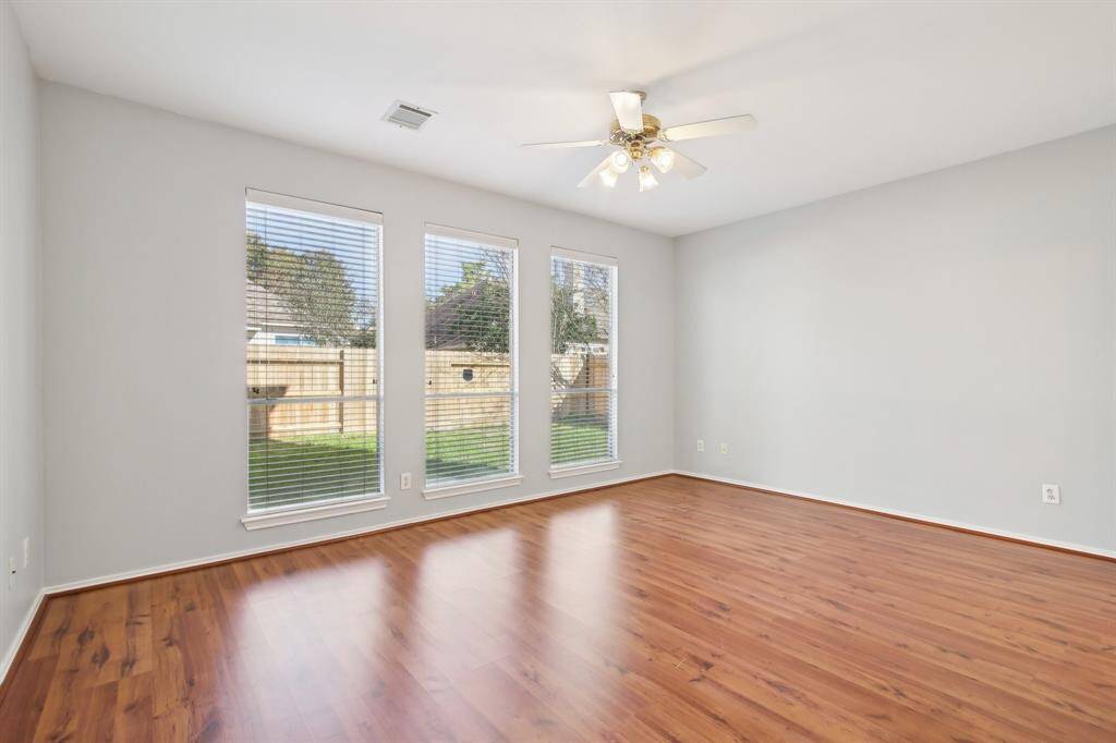 Primary bedroom with a view of the backyard.