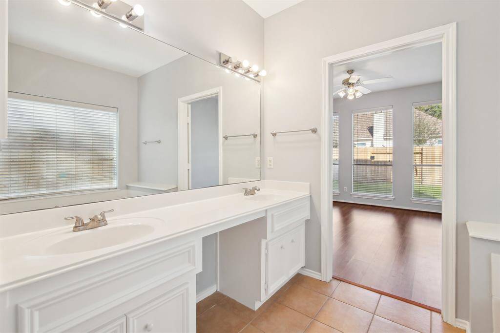 Primary bathroom with double sinks and a separate shower and tub.