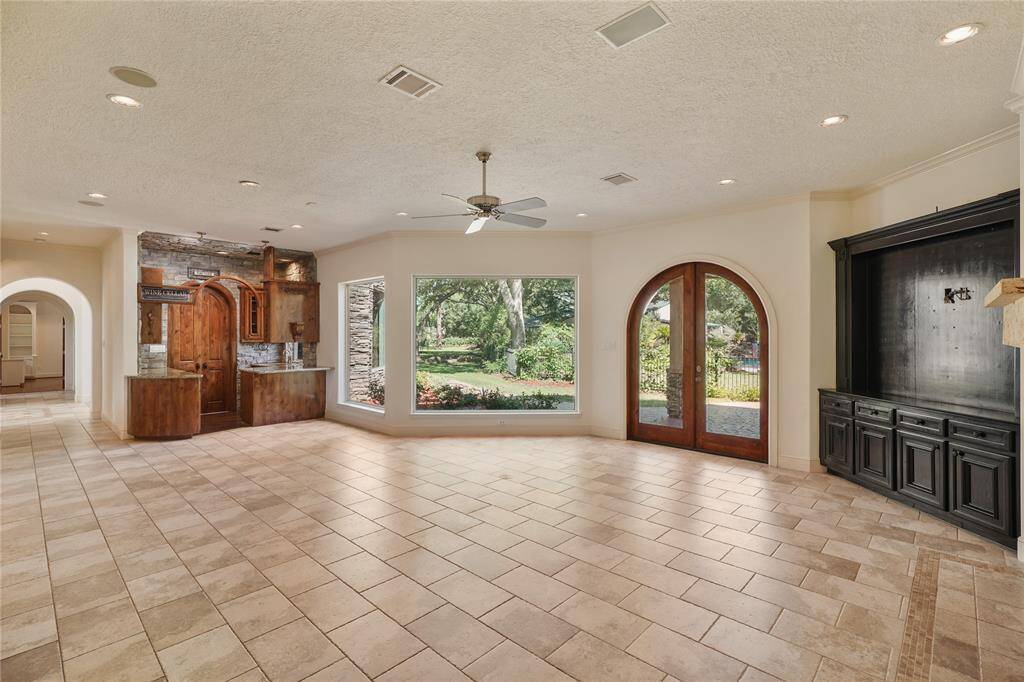 From every angle, the living room exudes warmth and sophistication - showcasing intricate archways, and panoramic views through oversized windows