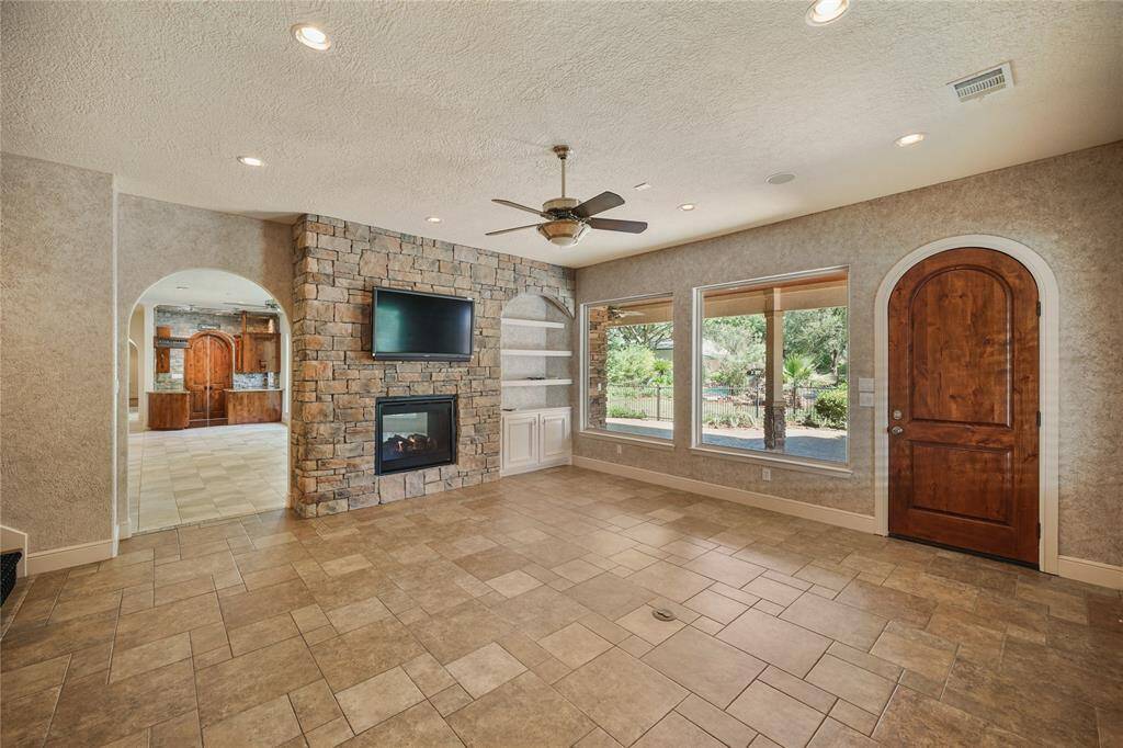 This inviting secondary living area features a stunning see-through fireplace shared with the main living room - creating a warm, connected ambiance while offering its own distinct charm and comfort