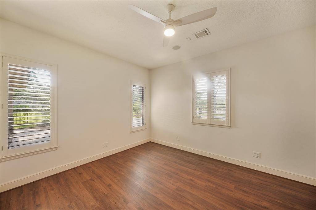 Charming secondary bedroom 15' x 13' on the main level, featuring an en suite bathroom for ultimate privacy and comfort - perfect for guests or family members