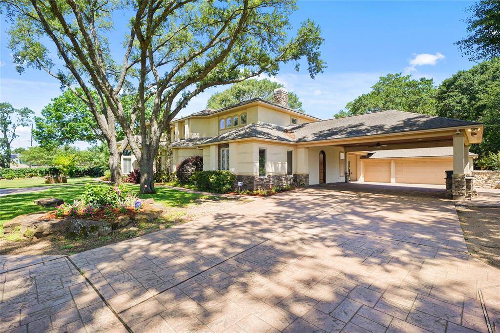 Expansive driveway and multiple parking areas provide ample space for guests