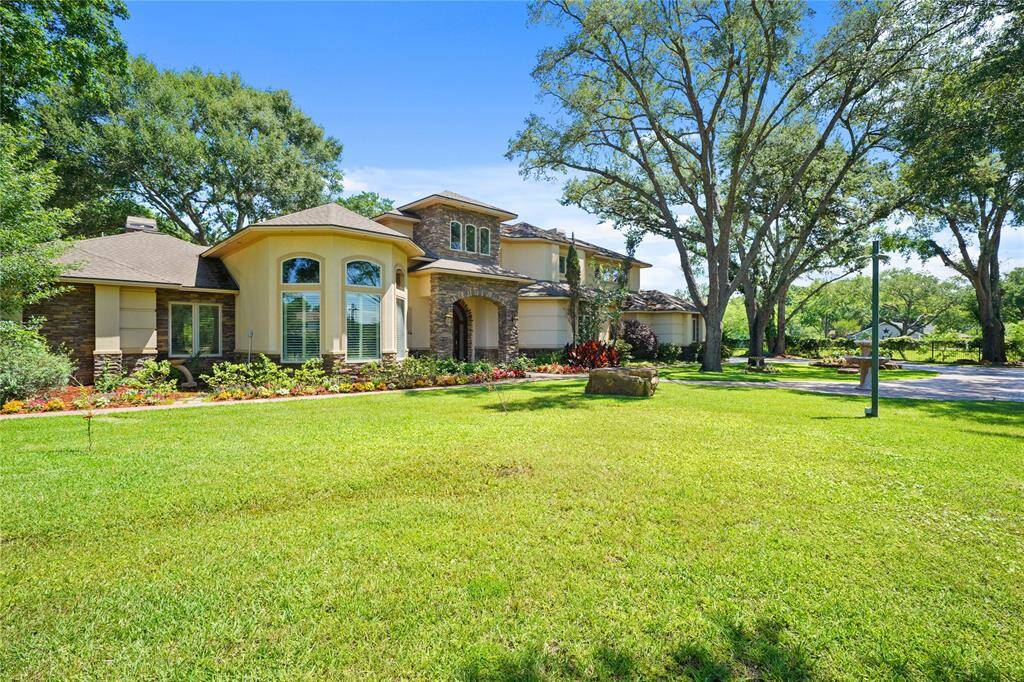 A captivating view of the home's front elevation, showcasing its architectural elegance and impressive curb appeal - a perfect introduction to this exceptional estate