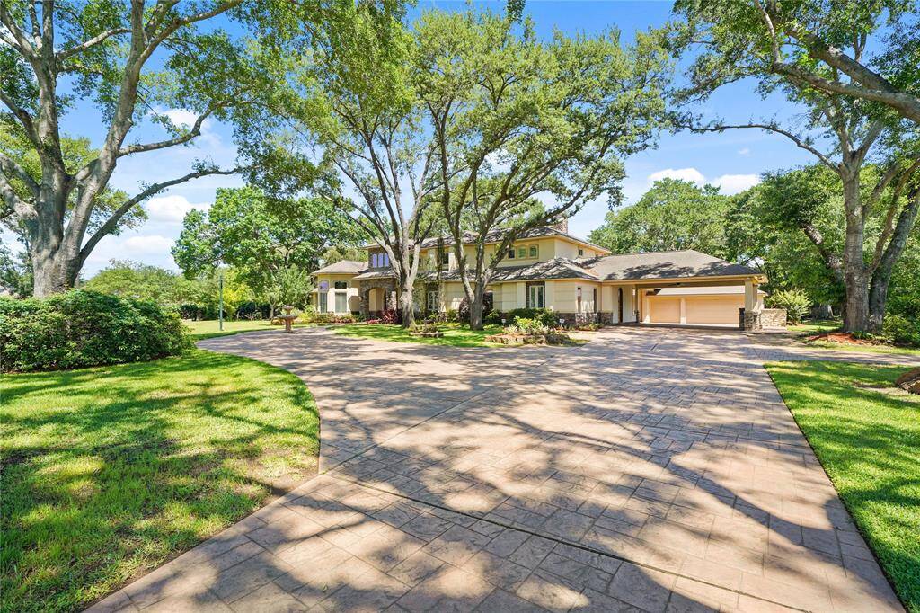 Upon entering the front gate there is ample parking and a canopy of mature trees - offering both privacy and a welcoming entry