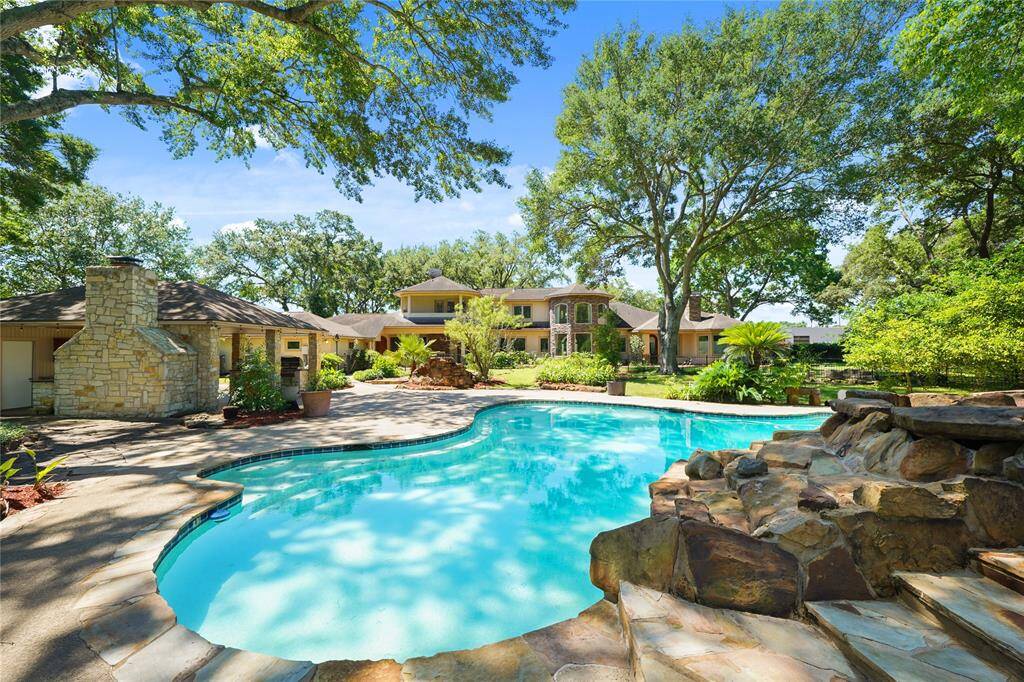 Serene and inviting pool area, surrounded by lush landscaping - the ultimate outdoor oasis for relaxation and entertaining