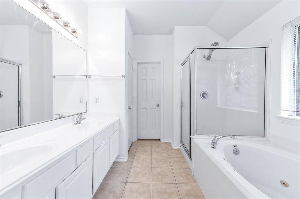 Primary bathroom with a separate shower and soaking tub for ultimate relaxation.