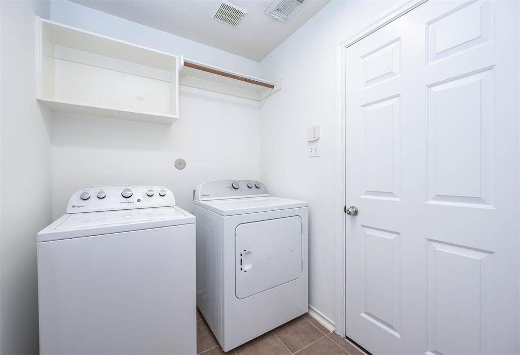 Utility room with washer and dryer.