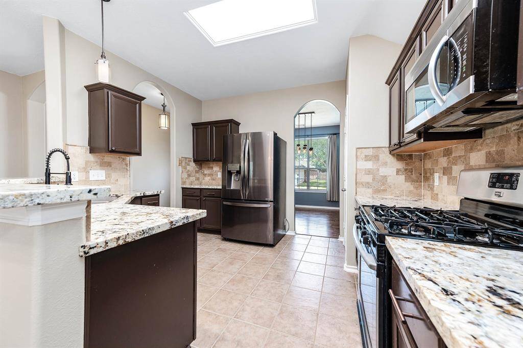 Alternate view showcases the kitchens layout and style.