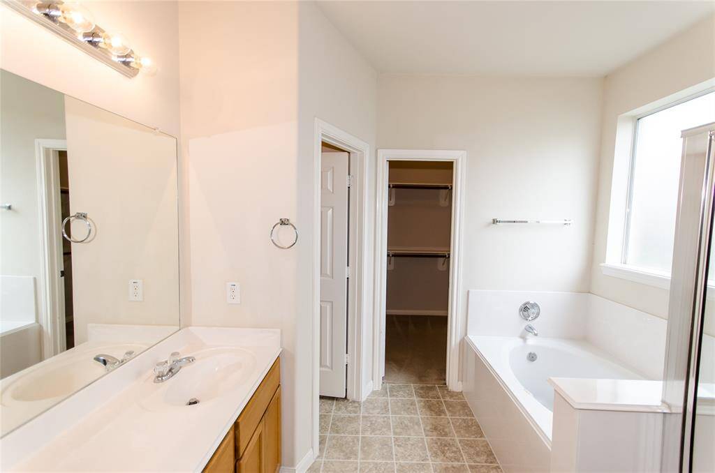 Dual sink Master Bathroom with Jacuzzi and Separate shower.