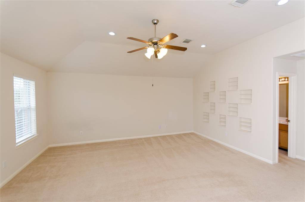 Another view of the gameroom. There are built in shelves in one wall.