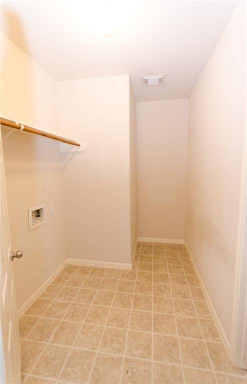 Second picture of utility room, notice the extra space for supplies and hamper.