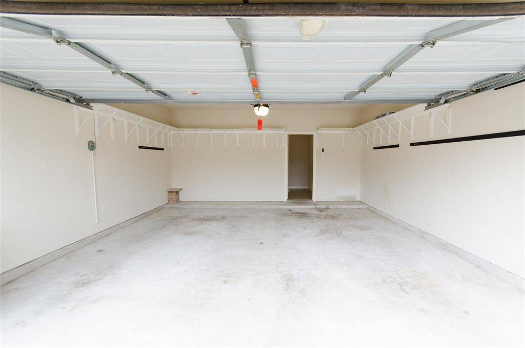 Garage has plenty of Shelving for storage.
