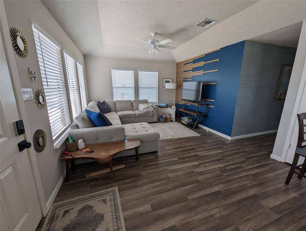 The living room has abundant natural light