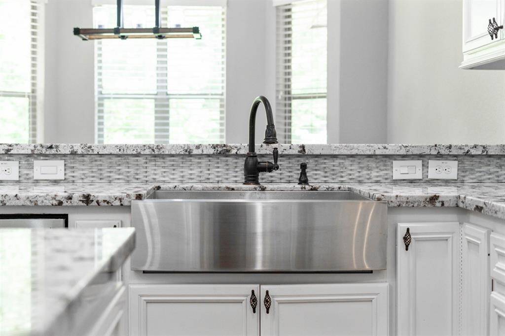 There is a ton of cabinet and drawer space in this kitchen! To the left of the sink is the cabinet that contains a turntable allowing for ease of access.