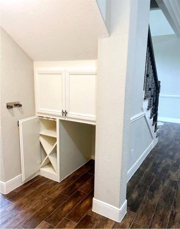 Open the cabinet door in the space under the stairs to find a wine nook.