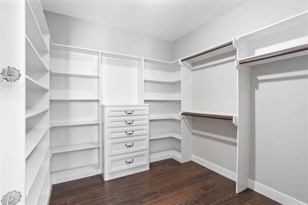 Ladies!!! This could be YOUR closet!! Imagine how many shoes could be stored on the shelves!! Notice to the left the cute antique jewelry spinners making organization for necklaces and bracelets easy.